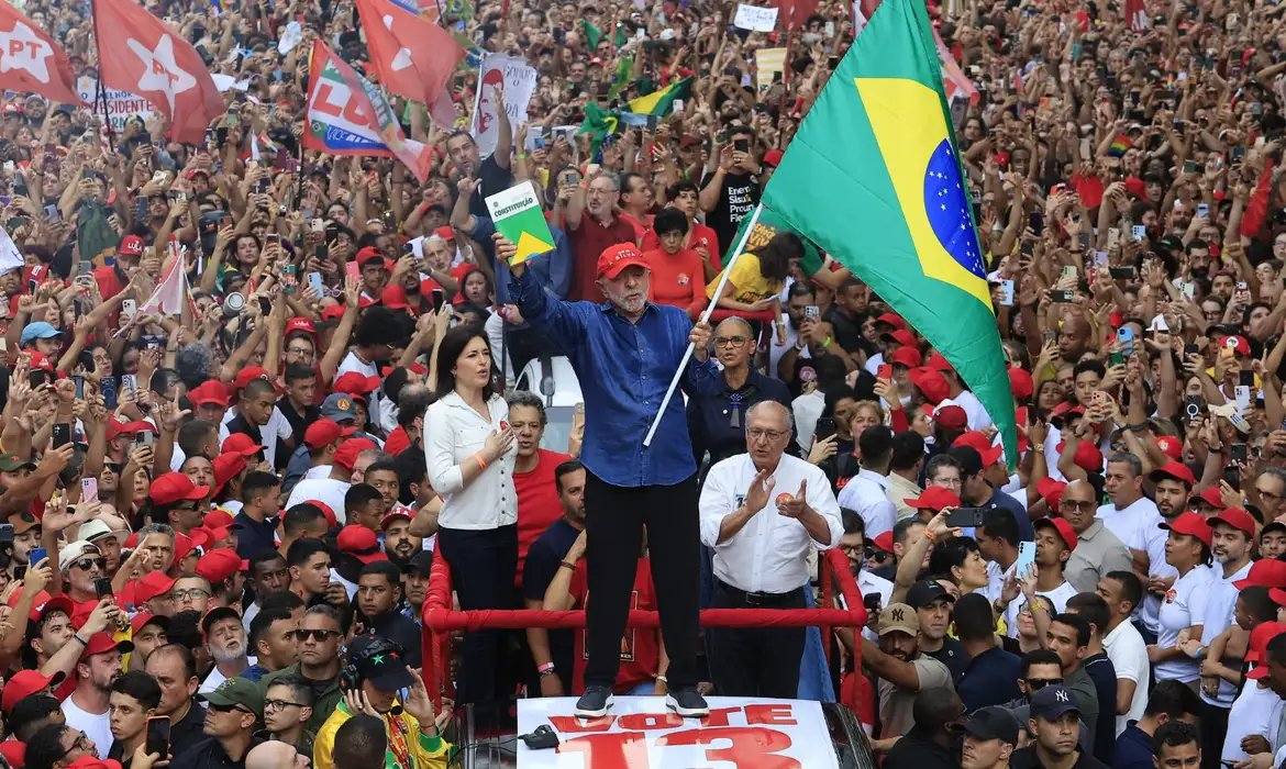 Lula com uma bandeira do Brasil diante do público, em imagem de arquivo